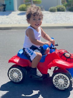 toddler riding a toy vehicle